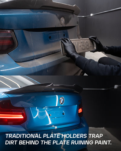 Removing license plate from blue BMW rear bumper to reveal paint damage caused by traditional screw-mounted holder